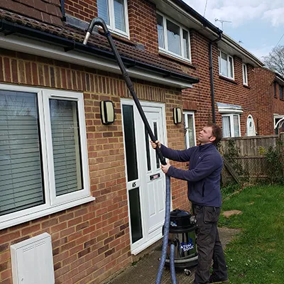washing the gutter near front door